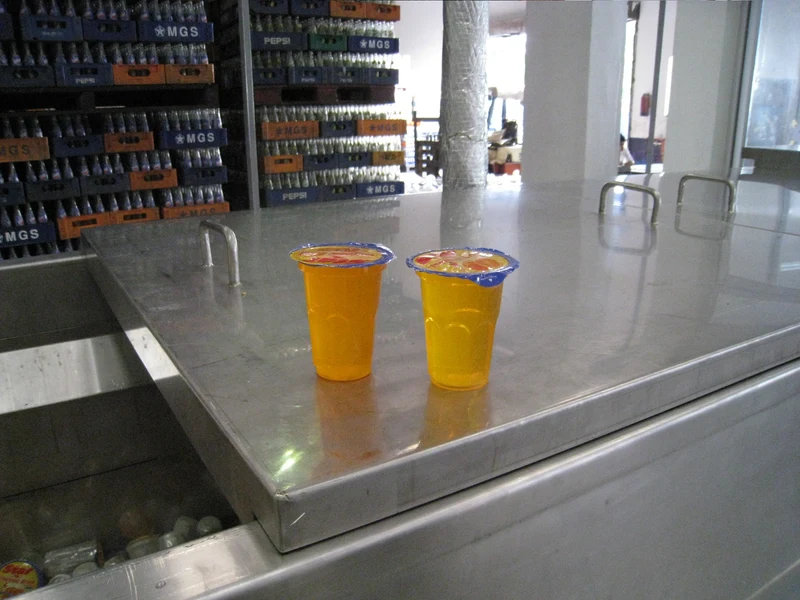 Finished foil-sealed juice cups straight off an EDELSTEIN filling line