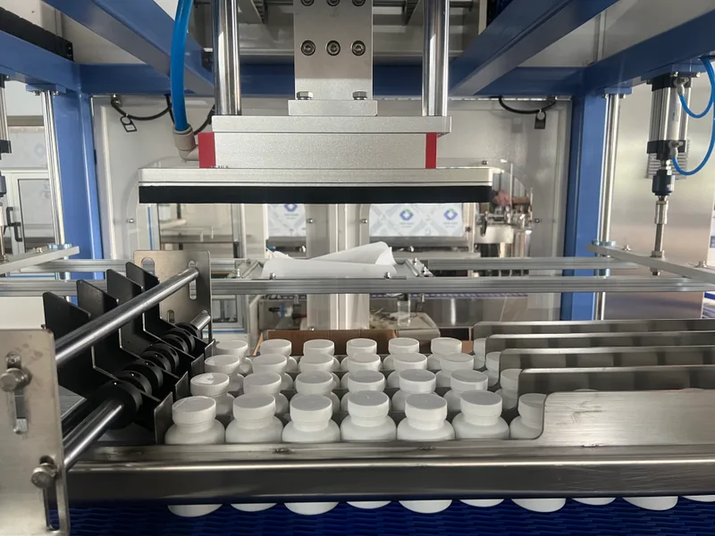EDELSTEIN vacuum-type case packer collating pharmaceutical bottles before carton loading